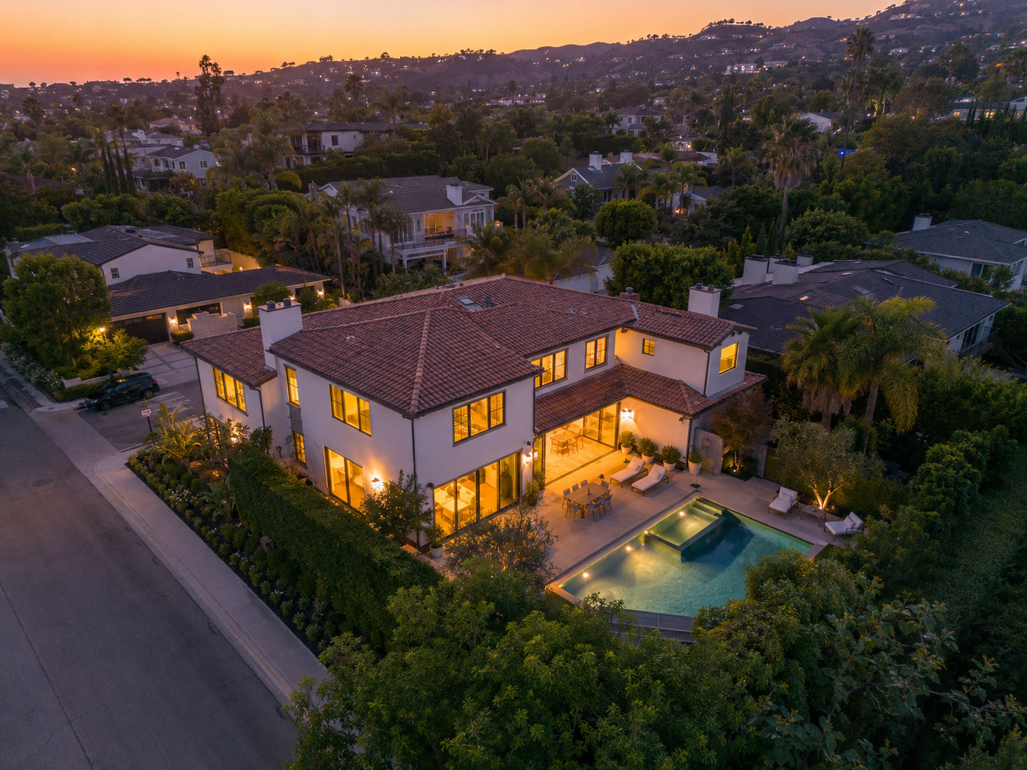 Aerial view of hillside home with pool