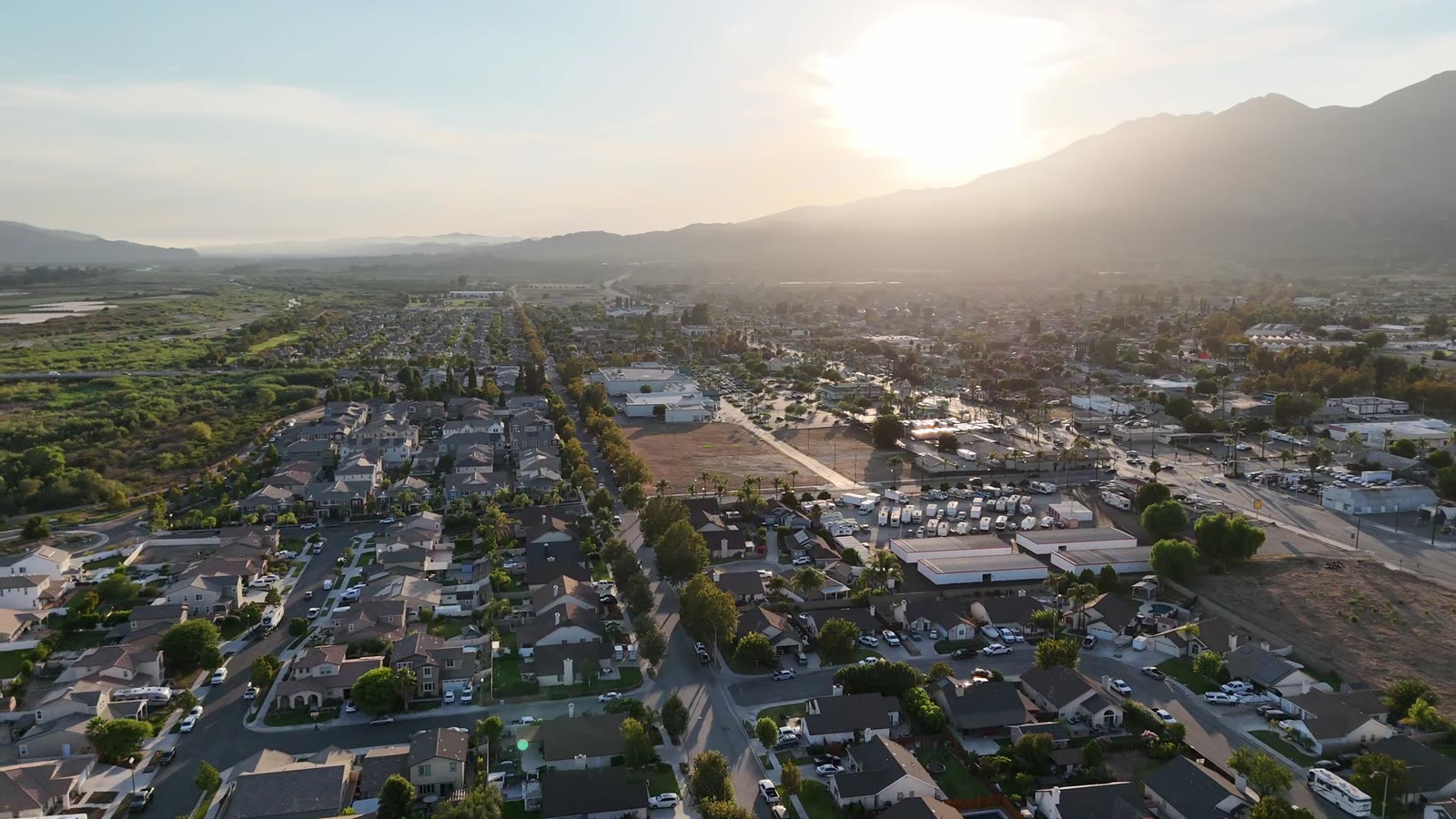 Morning aerial view across a California neighborhood toward the mountains