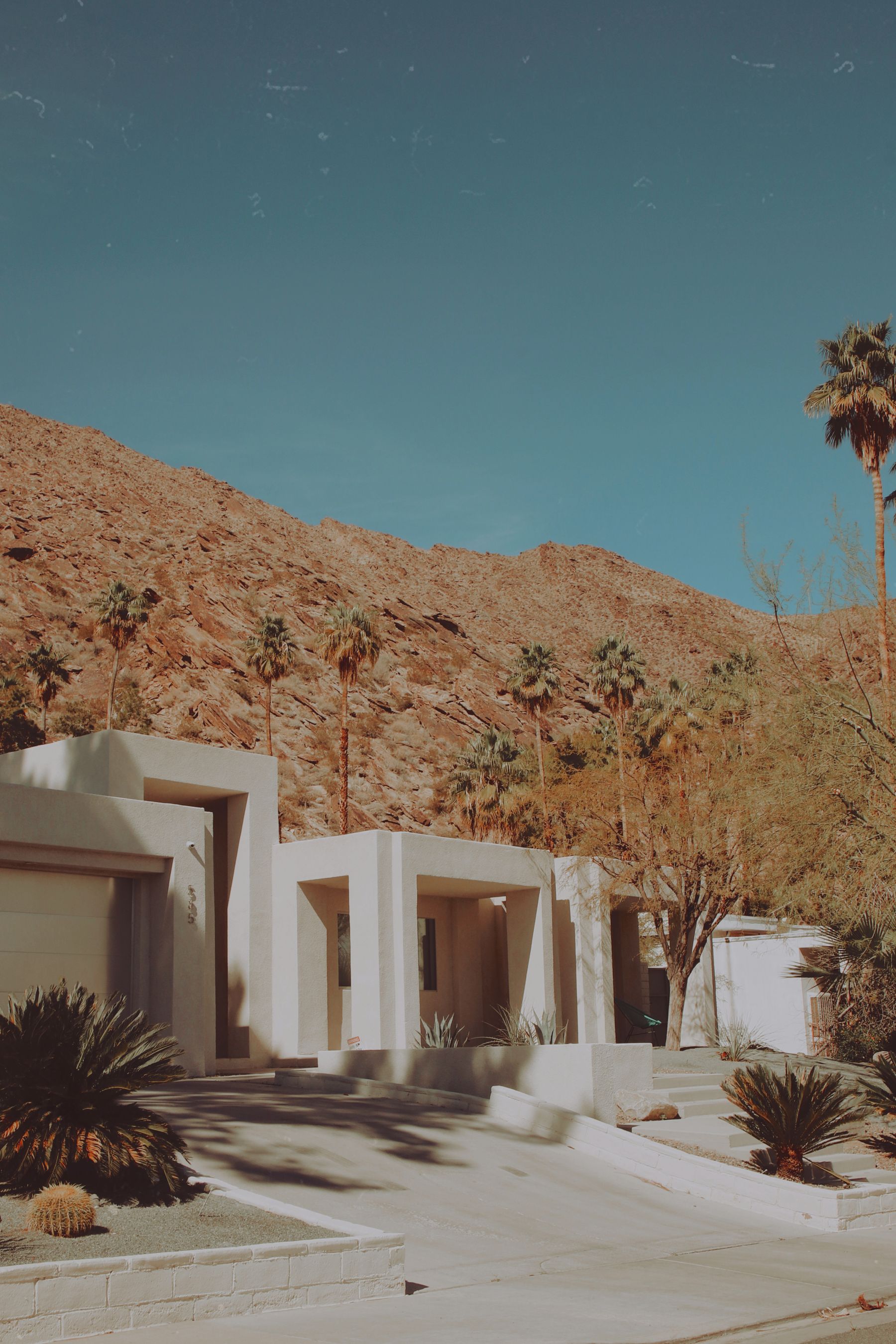 Modern Palm Springs villa set against desert mountains and sculptural landscaping