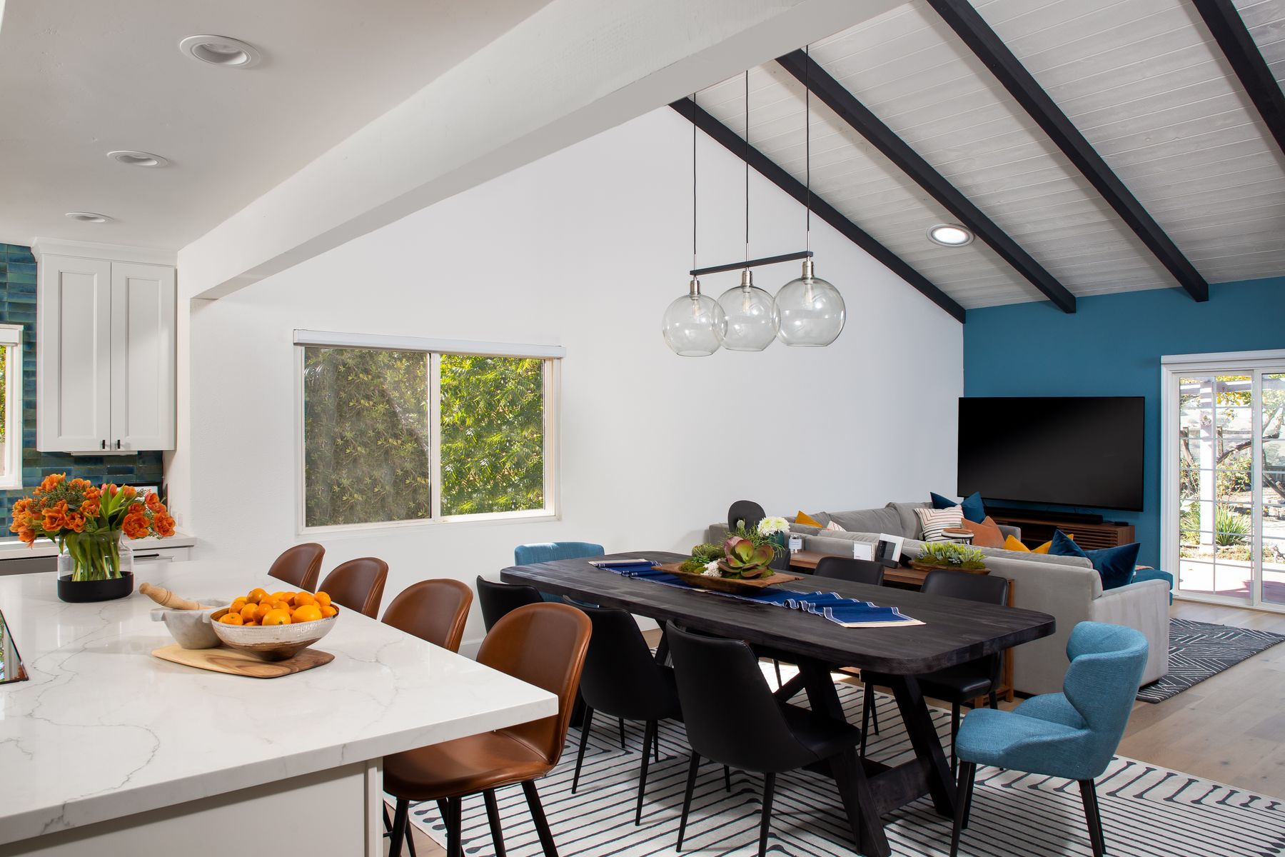 San Diego open-plan kitchen, dining, and living room with exposed ceiling beams